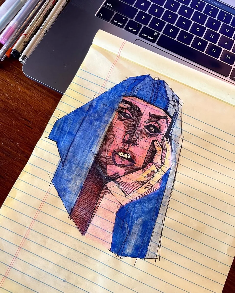 Cross-hatched ink portrait of a woman with blue hair, drawn on a yellow legal pad next to a laptop keyboard